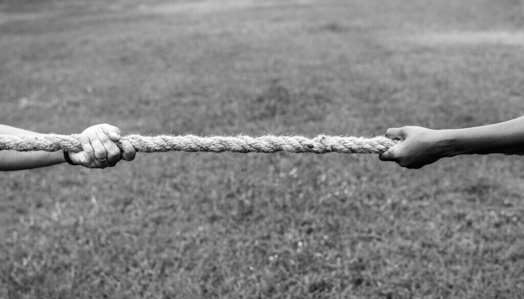 Closeup of hand pulling the rope in tug of war game