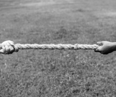 Closeup of hand pulling the rope in tug of war game
